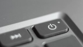 Turning on the laptop. The finger presses the start button on the computer. The laptop turns on and the warning light lights up. - Powered by Shutterstock - Get 15% off with code: PIKWIZARD15