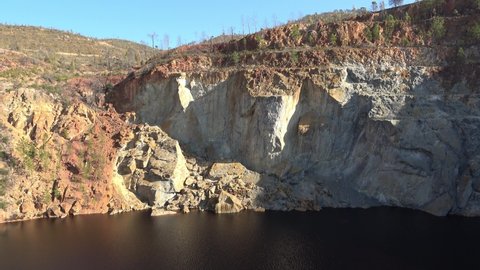 Panorama of Peña del Hierro open mine pit. Deep excavation of pyrite and extraction of minerals of copper and gold in municipality of Nerva, Huelva, Andalusia, Spain