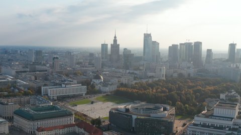 High angle view of palaces in old town district. Tilt up reveal of park and modern high rise office buildings in city centre. Warsaw, Poland