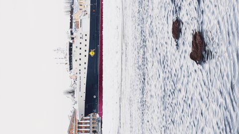 Russia, St. Petersburg, 07 December 2021: Slow motion footage of winter view of St. Petersburg at frosty weather, frozen Neva river, huge moored ship,