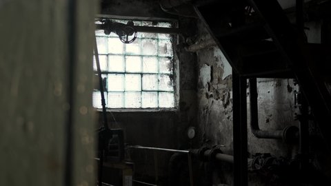 old abandoned factory, stained-glass windows through which sunlight shines through. General view of destroyed equipment inside Chernobyl plant.