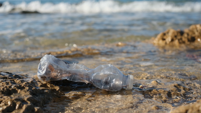 Plastic bottle discarded on pollution contaminated sea ecosystem, environment waste | Shutterstock HD Video #1084561474