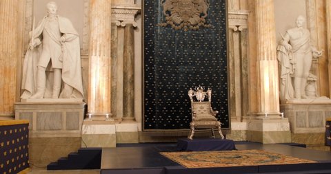 Stockholm, Sweden - December 2021. Throne placed in The Royal Palace with a golden background in Hall of State room. 4K