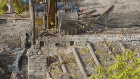 Destruction of ancient historical buildings, excavator breaks down an old vintage house. construction of new buildings on the site of abandoned housing concept. Urban Renewal 4k High quality video