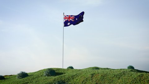 Australia, Australian flag waving in the wind on a beautiful landscape. Blue sky. 4K HD. Stunning image.