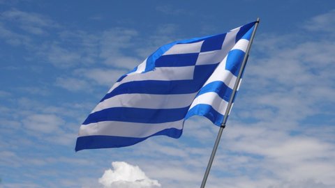 Greece Flag Waving in the Wind in Slow Motion Close Up with blue sky background. High quality 4k footage