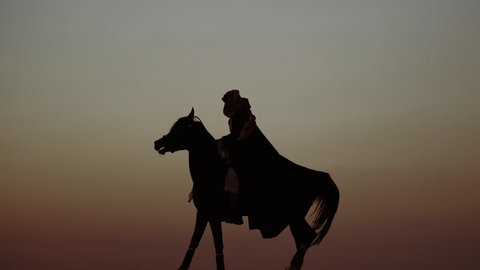 An Arab Person With Horses in the desert at sunset 6