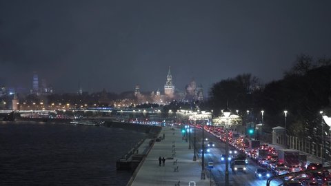 New Year's Winter traffic jam on the embankment against the background of the Moscow Kremlin at night