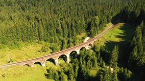 Drone flight over an ancient Austrian viaduct on a summer day. Bird's eye view. Location place Carpathian mountains, Ukraine, Europe. Cinematic top down shot. Filmed in UHD 4k video. Beauty of earth.