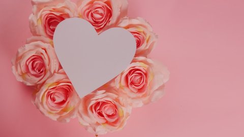 St. Valentine's Day. Greeting card. Pink roses on a pink background in the center of a white heart.