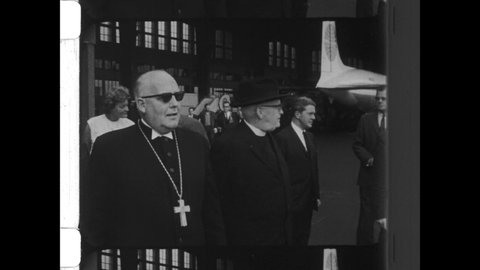 1964 Oslo, Norway. Martin Luther King arrives at airport greeted by Catholic Priest and News Reporters. 4K Overscan of Vintage Archival 16mm Newsreel Film