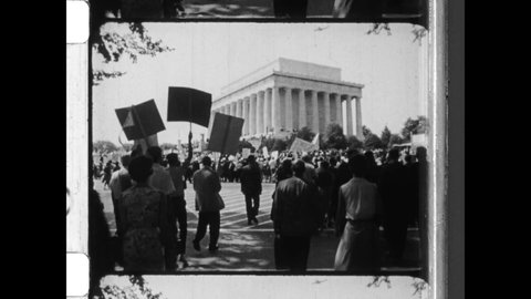 1963 Washington, DC. Civil Rights Supporters march on Washington to listen to Martin Luther King deliver his 'I Have a Dream' Speech. 4K Overscan of Vintage Archival 16mm Newsreel Film Print