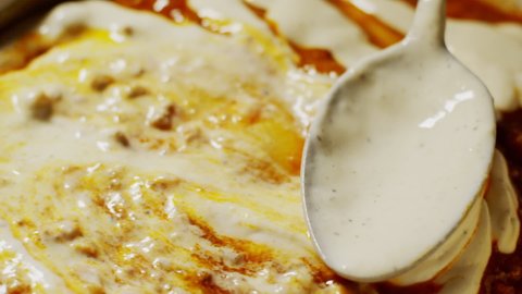 Bechamel sauce topping in a lasagne, italian food flavours, close up background