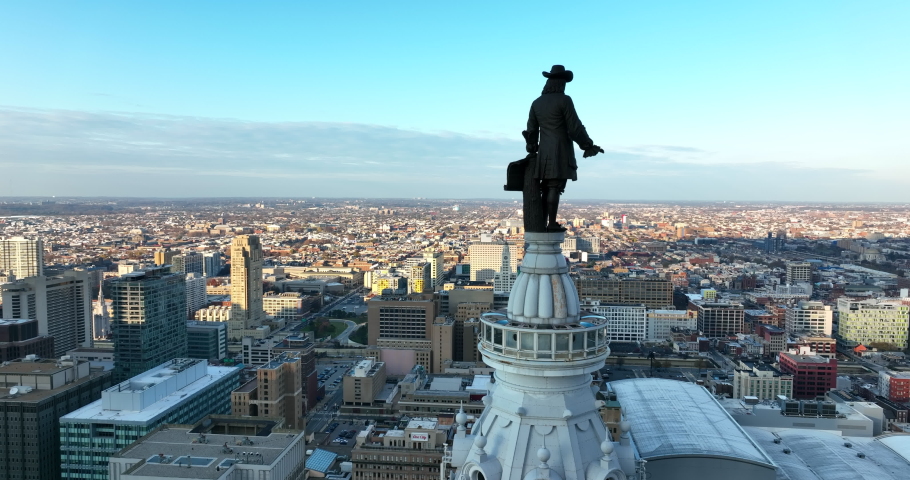 William Penn statue at Philly City Hall. Rising reveal of North Broad Street in Philadelphia. Aerial drone shot.