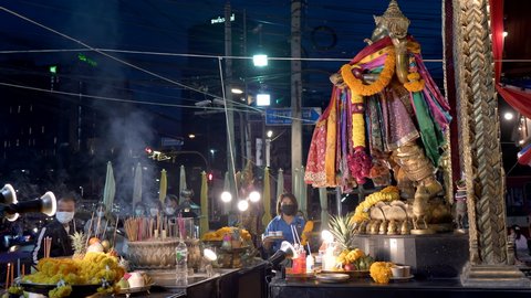 Asian young women worship praying to Ganesh God for love and luck offer drink and flowers. Ganesh Shrine temple, joss sticks smoke. 10bit, 422. Huai Khwang, Bangkok, Thailand 15 Nov 2021
