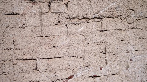 Abstract background. Building facade of old dirty white brick wall background. Empty wall from white brick. Camera moving. Close up