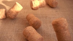 Champagne wine corks fall onto the burlap. Slow motion. - Powered by Shutterstock - Get 15% off with code: PIKWIZARD15