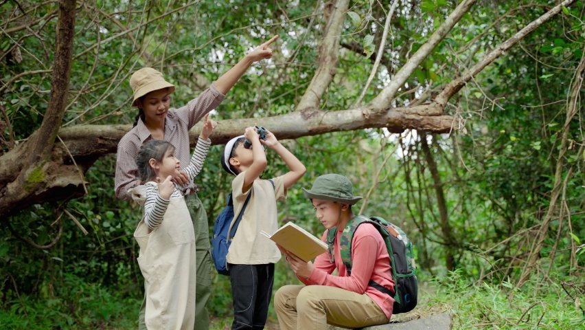Asian female teachers are taking students on a nature trail to study nature from real places, educational concepts, adventures.
