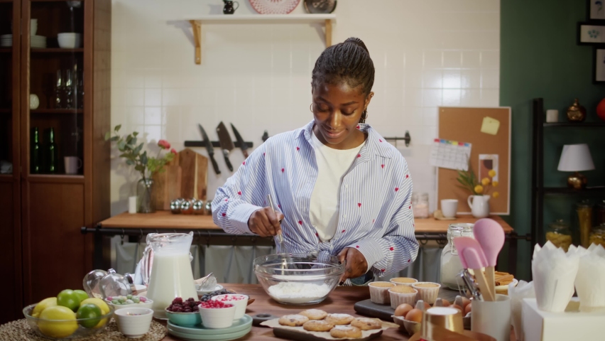 African american chef cooking biscuits. Confectioner woman preparing ingredients for cookies, mixing, making dough. Baking food, homemade treats. Bakery at home. - Powered by Shutterstock - Get 15% off with code: PIKWIZARD15