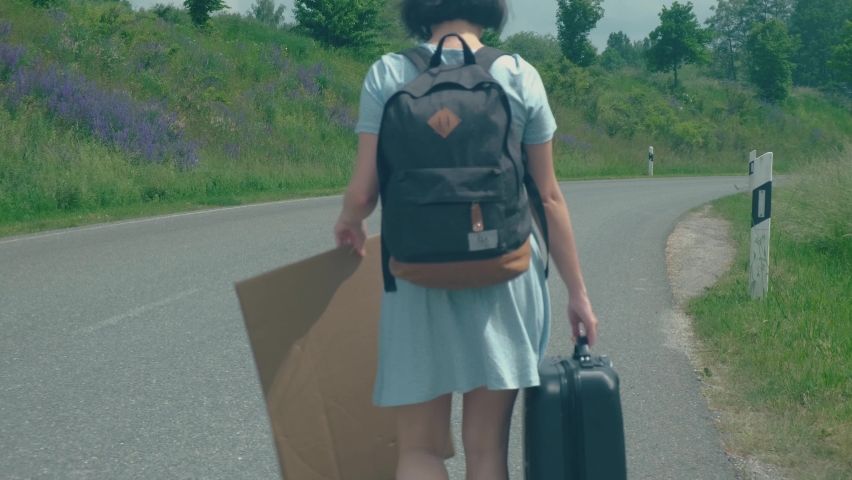 Girl with a backpack hitchhiking