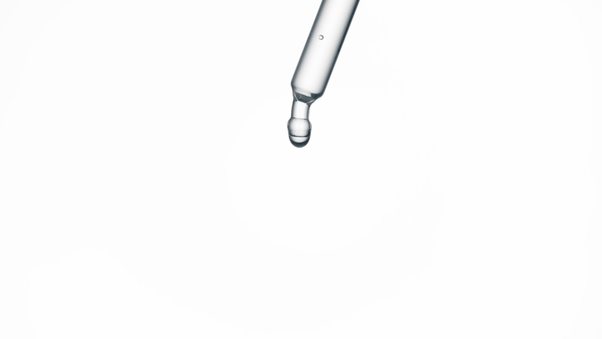Macro shot of drop of grey fluid is falling down from pipette on white background. Abstract body care serum with hyaluronic acid formulation concept Royalty-Free Stock Footage #1084619497