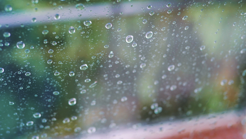 Rainy day behing the window in 4k slow motion 60fps