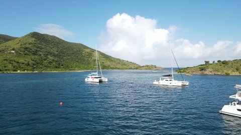Catamaran yachts in Diamond Cay, near Foxy's Taboo. Beautiful waters and yachts of the British Virgin Islands. Sunny, beautiful day