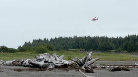 Floatplane Flying Over Field In Alaska At Daytime. tracking shot