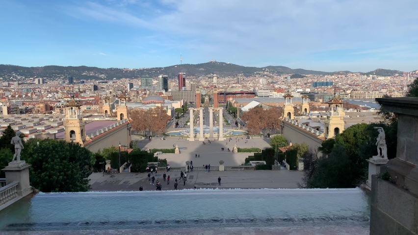 Running Montjuic palace fountain. Placa d'Espanya and famous Magic fountain of Montjuic in the background. Skyline of Barcelona city. Panoramic, scenic view. Barcelona, Catalonia, Spain | Shutterstock HD Video #1084628065