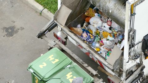 Workers collect mixed waste operating garbage truck, stock footage, Moscow, 14 Sept 2021