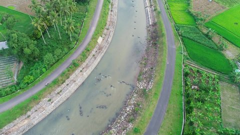 Drone flying over Batang Agam river, Tilt Reveal Drone Shot, West Sumatra