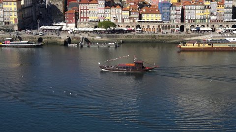 View on a traditional boat with tourists sailing the Douro river seen from the cable car in the center of Porto, Portugal, November 9 2021
