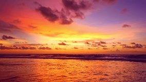 Tropical sea at sunset or sunrise over sea video 4K, The sun touches horizon, Red sky in golden hour amazing seascape,Ocean beach sunsets,The sun in spindrift clouds Fantastic natural sunsets