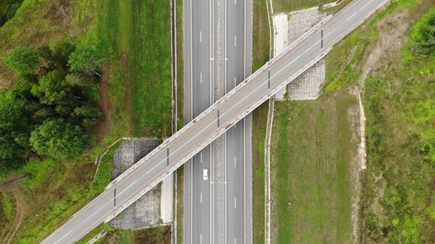 federal Highway bridge crossroads in summer forest. modern straight road track. Moscow Saint Petersburg motorway M11 Neva in Russia. Aerial drone view. Flying over. Drone is standing