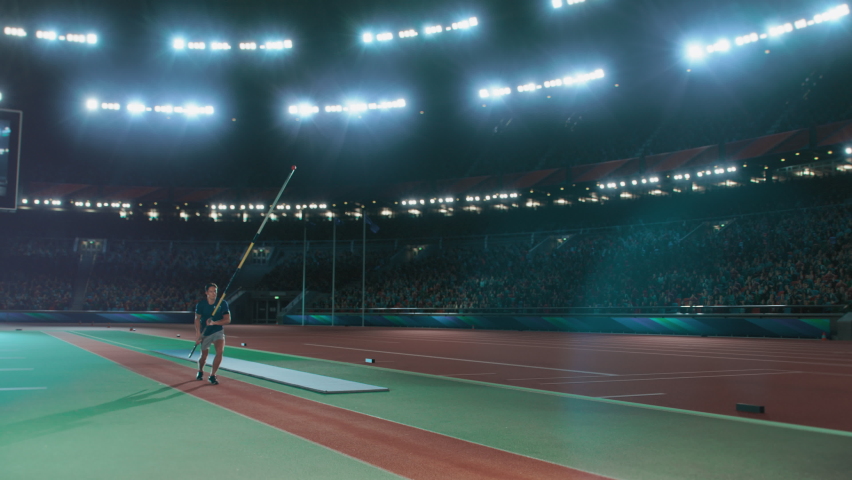 Pole Vault high Jumping Championship: Professional Male Athlete Running with Pole Successfully Jumping over Bar and Landing on His Feet, Celebrates Record-Setting Victory with Stadium Crowd Cheering | Shutterstock HD Video #1084634638