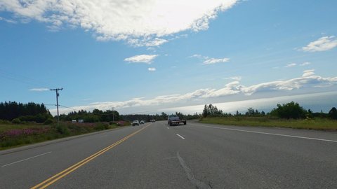Homer , Alaska , United States - 12 27 2021: Point of view bike riding beautiful asphalt road by the sea with blue sky near Homer, Alaska