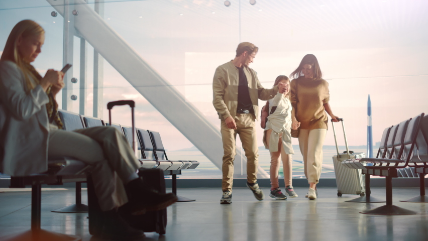 Airport Terminal Family Reunion: Caring Father Meets His Cute Little Daughter and Beautiful Wife at the Boarding Lounge of Airline Hub. He Picks Up and Dances with Lovely Child and Hugs His Partner | Shutterstock HD Video #1084638280