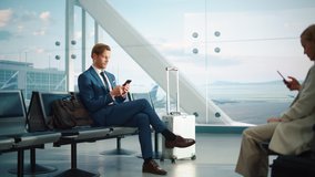 Airport Terminal: Businessman Uses Smartphone, Waiting for a Flight, Doing e-Business, Sending e-Commerce emails. Traveling Entrepreneur Remote Work Online Sitting in a Boarding Lounge of Airline Hub - Powered by Shutterstock - Get 15% off with code: PIKWIZARD15