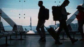 Busy Airport Terminal: Diverse Multi-Ethnic Crowd of People Walking, Hurry or Wait for their Flights. People Sitting in a Boarding Lounge of Big Airline Hub with Airplanes Departing and Arriving - Powered by Shutterstock - Get 15% off with code: PIKWIZARD15