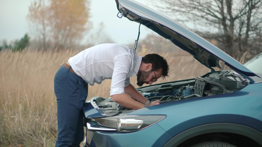 Confused Driver Fixing Broken Car. Auto Engine Failure. Car Accident Breakdown Inspecting. Driver Repair Damage Vehicle. Automobile Problem On Roadside. Suv Malfunction Trouble On Road Trip Driving | Shutterstock HD Video #1084642261