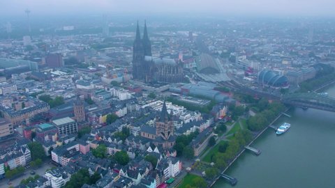 Aerial panorama view of the old town of cologne on a rainy, cloudy and foggy morning in summer.
