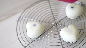 Pastry chef is glazing individual mousse cakes with a mirror glaze - Powered by Shutterstock - Get 15% off with code: PIKWIZARD15