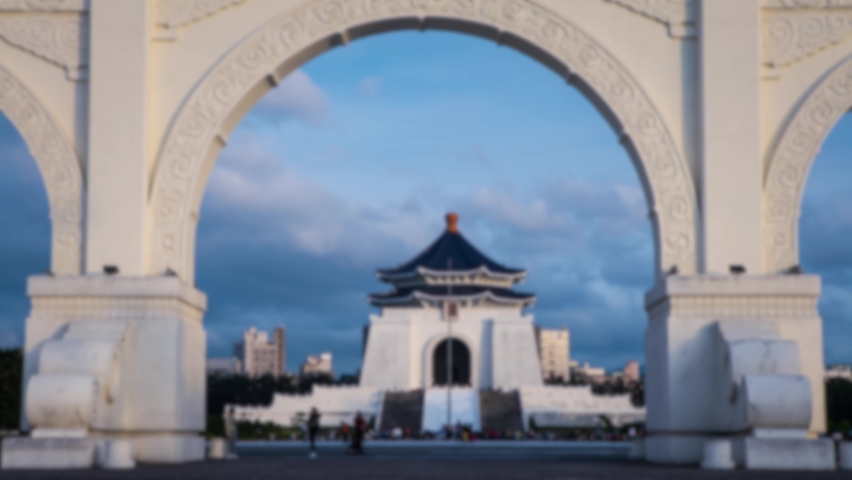 Blurred defocused view of Timelapsed of people walking around and Chiang Kai Shek memorial hall in Taipei, Taiwan. Timelapse of the majestic monument. Tourist attraction