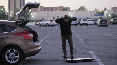 Man drops a new purchased TV on a supermarket parking, unsuccessfully delivered it to the car trunk, funny fail