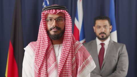 Medium slowmo portrait of two Arab and Middle-Eastern country leaders posing for camera