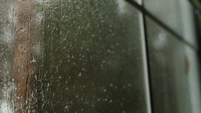 Rain drop on window with blur background negative space on right side.