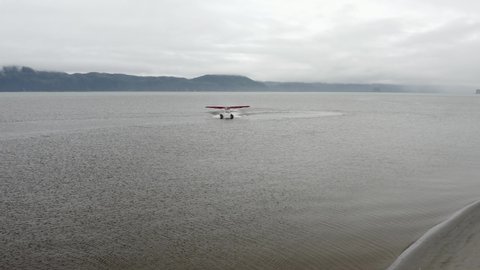 Floatplane Taxiing On Water Surface For Take Off In Alaska. tracking shot