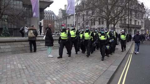 London , United Kingdom (UK) - 12 18 2021: A unit of riot police march at a public order event