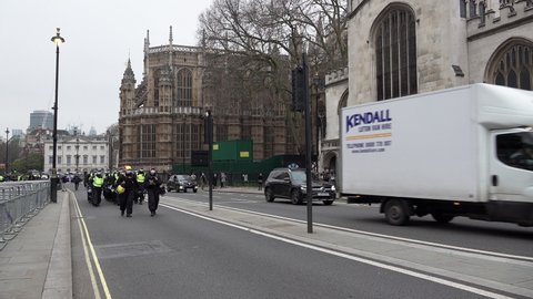London , United Kingdom (UK) - 12 18 2021: A unit of riot police march forward and come to a halt