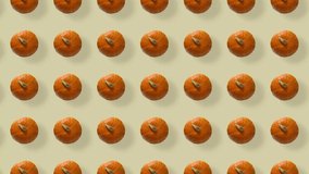 Colorful pattern of fresh orange pumpkins. Top view. Seamless pattern with pumpkin. Pop art design. Realistic animation. 4K video motion